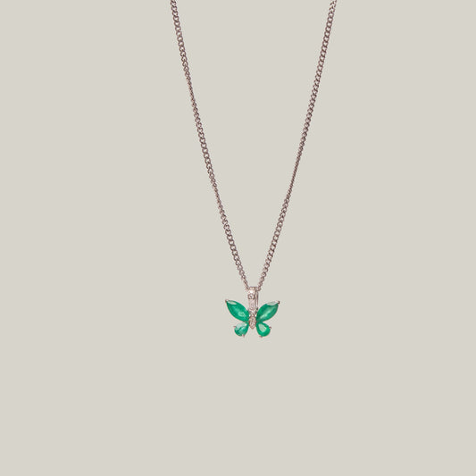 Necklace with a green butterfly pendant on a light gray background