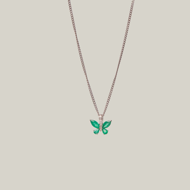 Green butterfly pendant on a light gray background