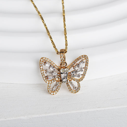 A gold pendant in the shape of a butterfly with diamond wings, displayed against a white background.
