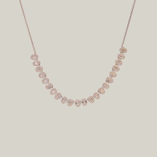 Gold necklace with diamonds in a curved pattern on a light gray background