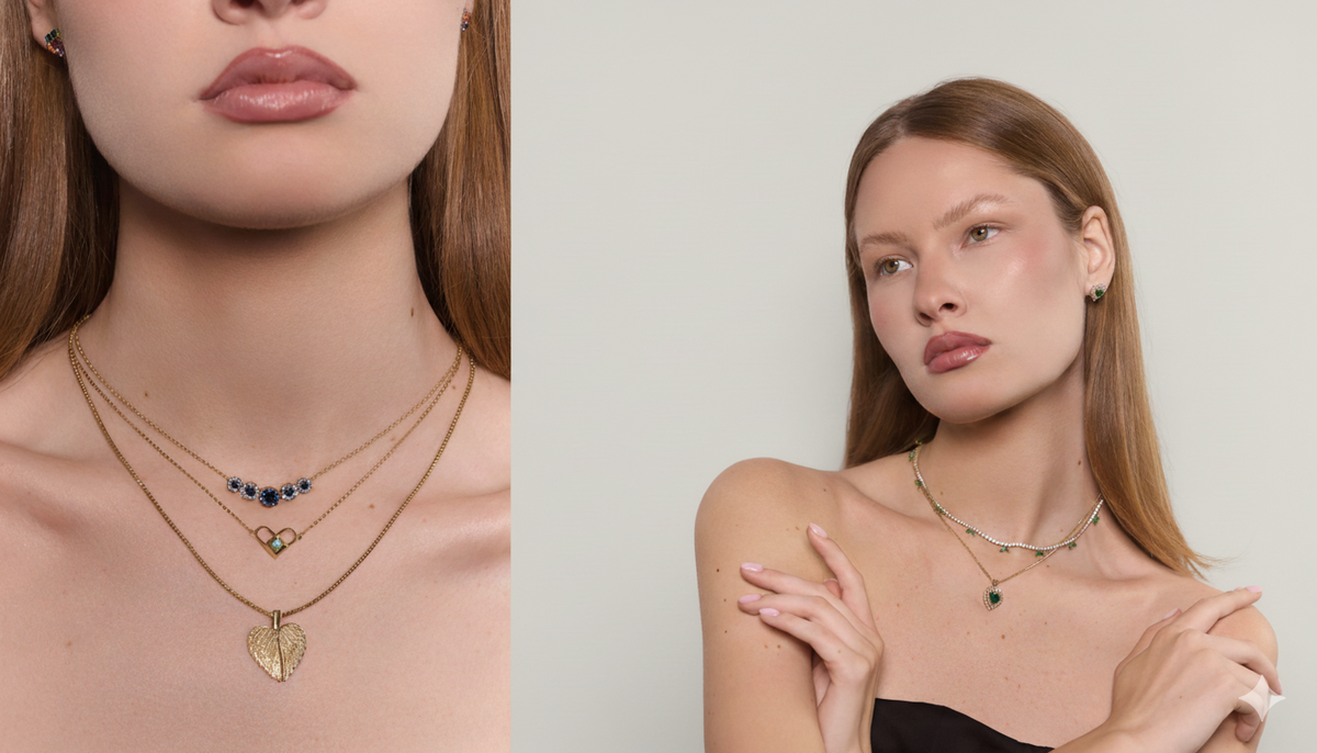 Close-up cropped view showcasing layered blue sapphire, angel wings and heart necklaces with rainbow gemstone earrings.
